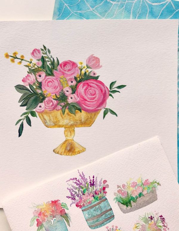 Pink flowers in gold urn